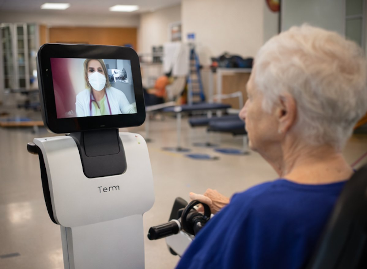 Elderly patient speaking with physician through telepresence robot