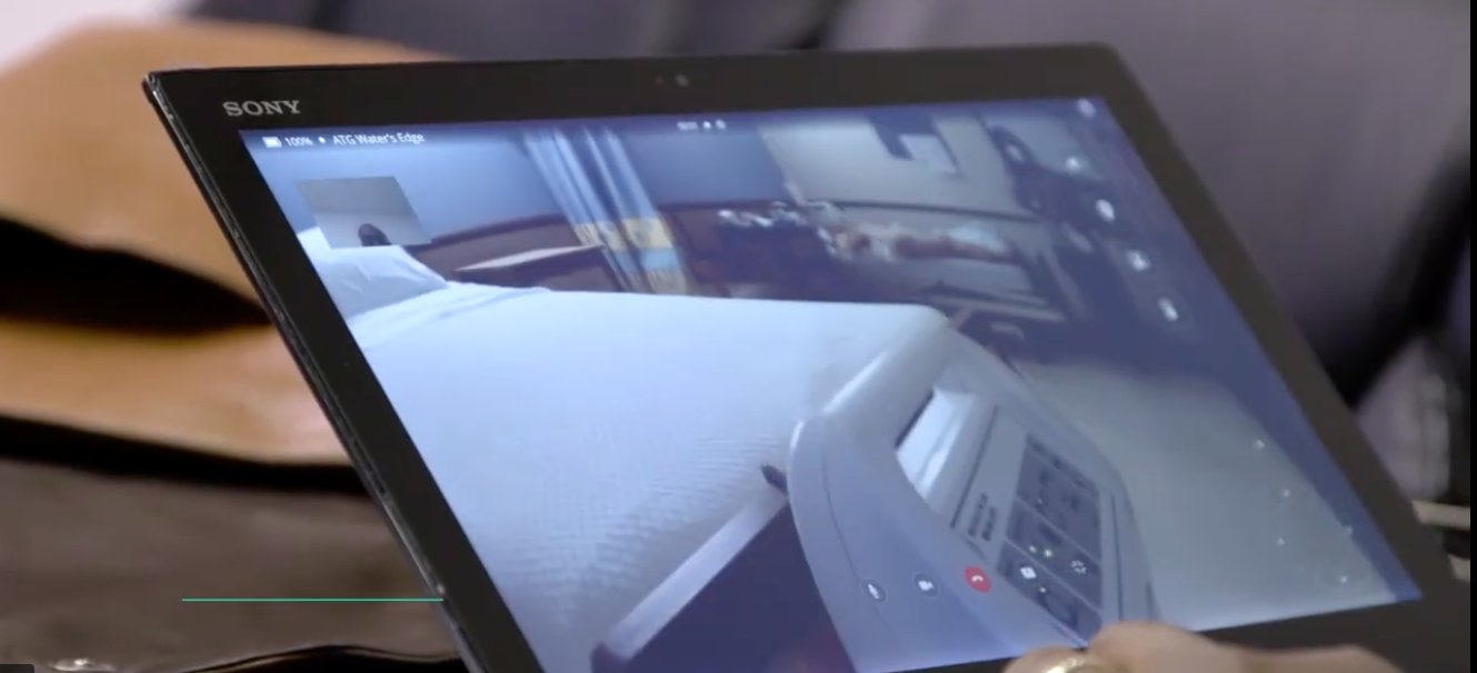 Physician remotely viewing patient room via tablet
